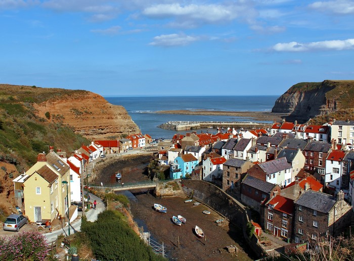 Coastal village with harbor and cliffs, United Kingdom