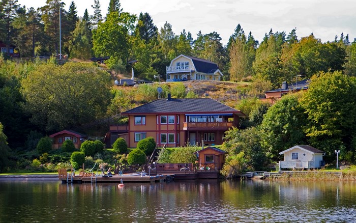 Houses on a hill by a lake in Sweden