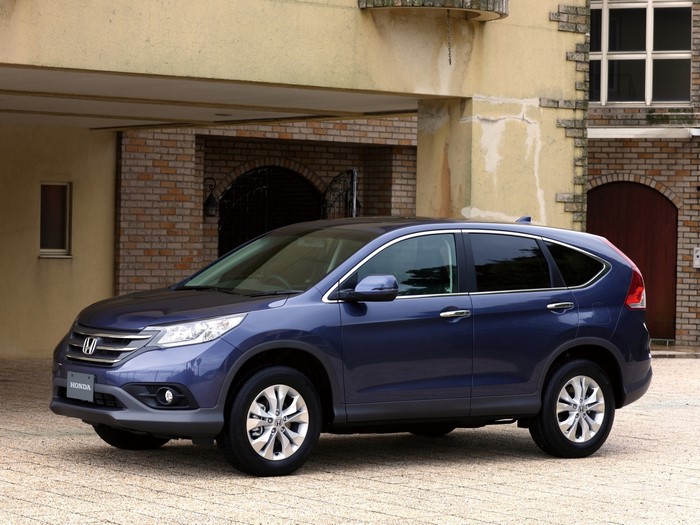 Blue Honda CR-V parked in front of a building