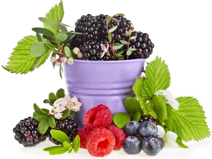 Blackberries, raspberries, and blueberries in a purple bucket