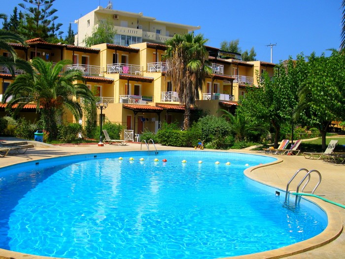 Resort with a swimming pool and palm trees