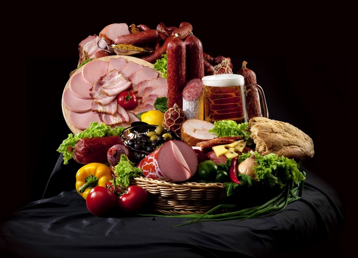 Assortment of cured meats, cheese, bread, and beer