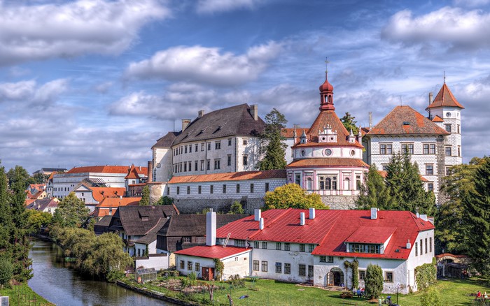 Castle and town by a river in the Czech Republic