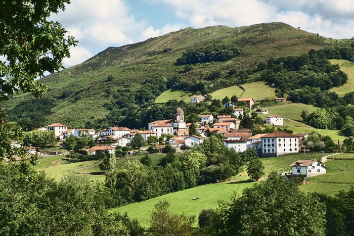 Village nestled in a green mountain valley in Spain