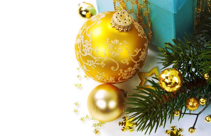 Christmas ornaments and pine branches on white background