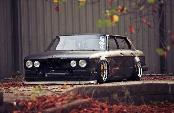 Matte black BMW E30 sedan with Rotiform sticker