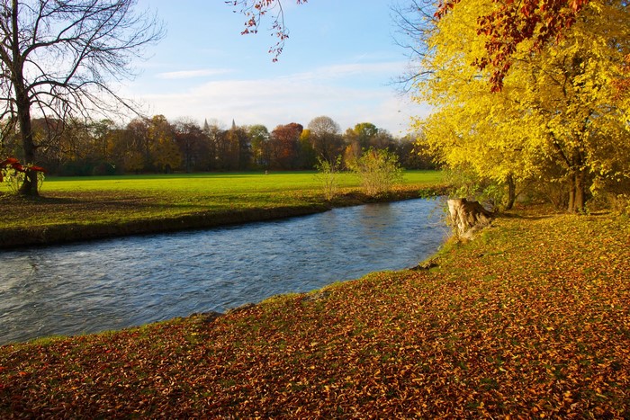 River in autumn park with colorful trees in Munich, Germany