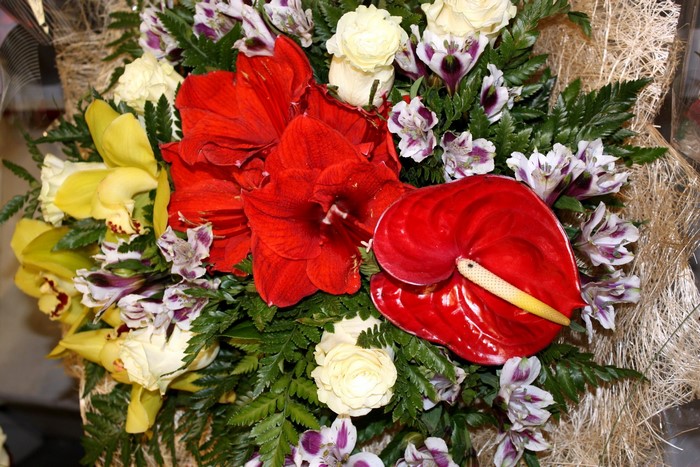 Bouquet of red amaryllis, yellow orchids, white roses, and anthurium