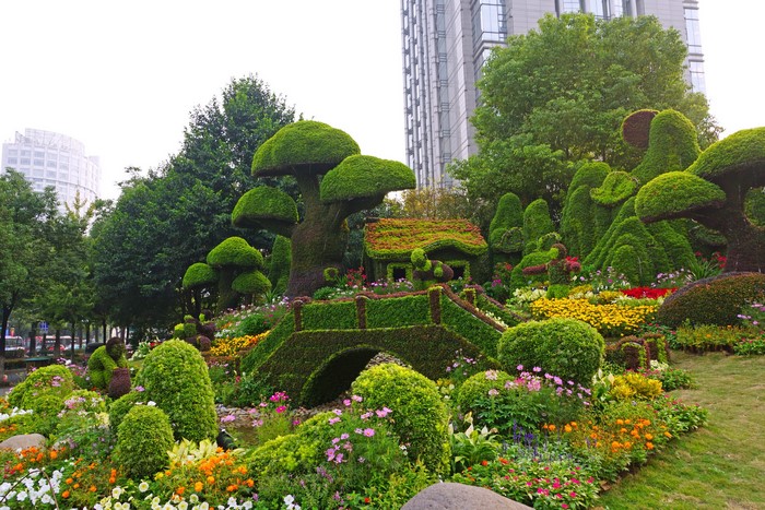 Topiary garden with a house and bridge in China