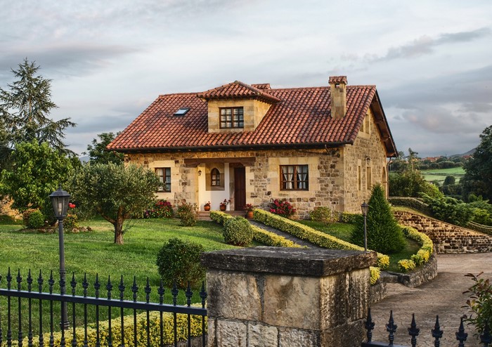 Stone house with red tile roof in Spain