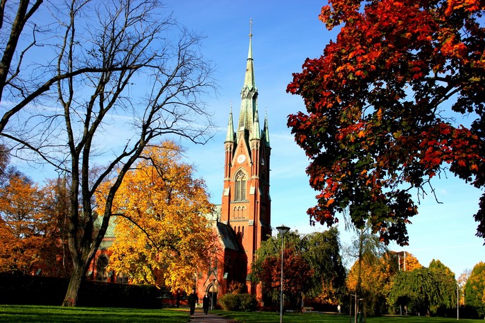 Church tower surrounded by autumn trees in Sweden