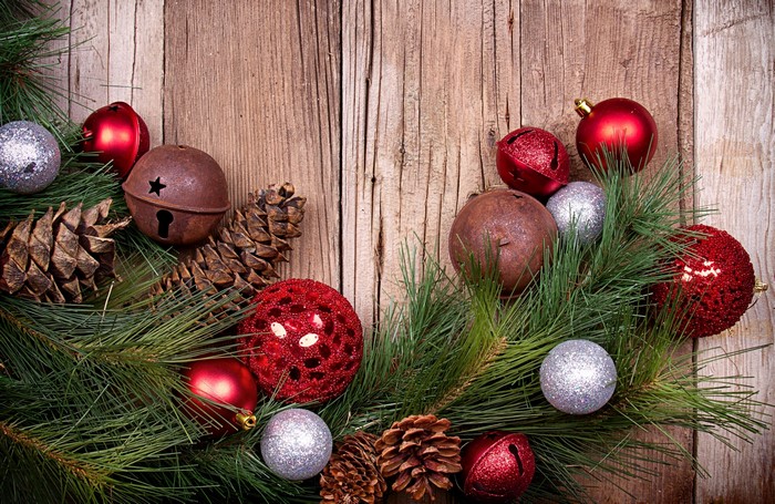 Christmas ornaments and pine cones on wooden background