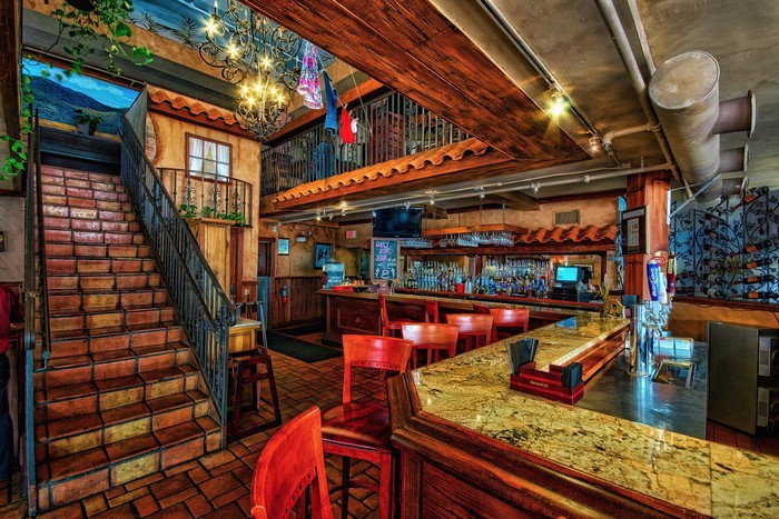 Interior of a restaurant with stairs and a bar
