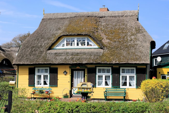 Yellow house with thatched roof in Germany