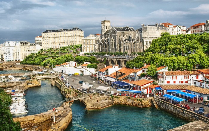 Coastal town with church and harbor in France
