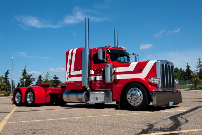 Red Peterbilt 389 Semi-Truck with White Stripes