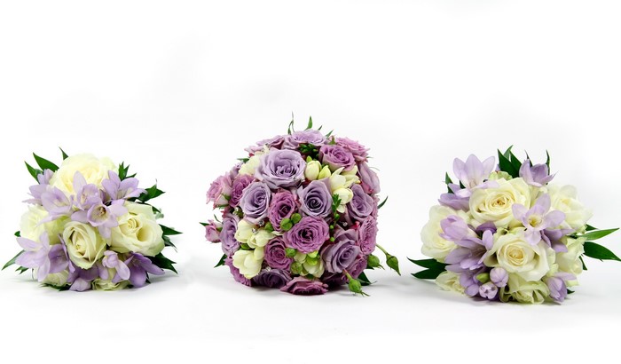 Three wedding bouquets with roses and freesia