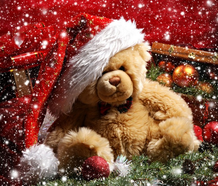 Teddy bear in Santa hat with Christmas decorations