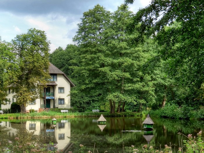 Hotel by a pond with duck houses in Germany