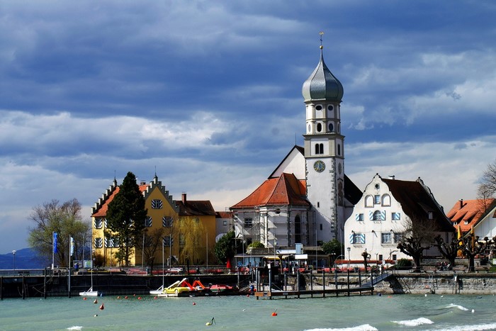 Church tower and buildings on a lake in Germany