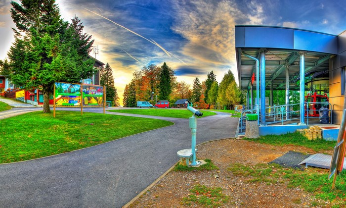 Cable car station with trees and sky