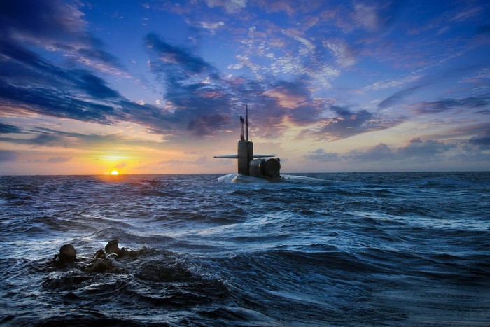 Submarine at sunset with divers in the ocean