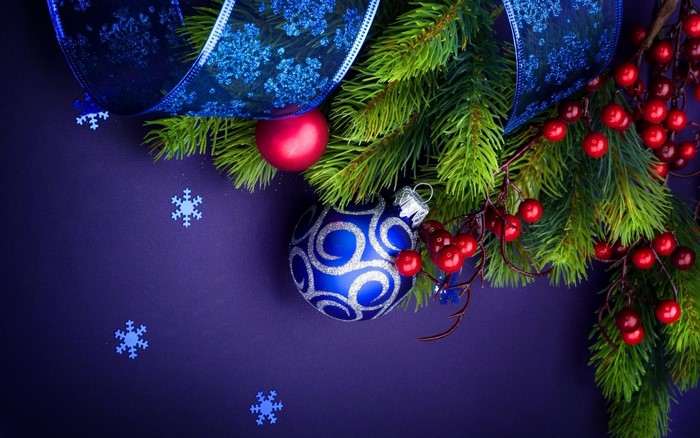 Christmas Ornaments and Pine Branches with Blue Ribbon