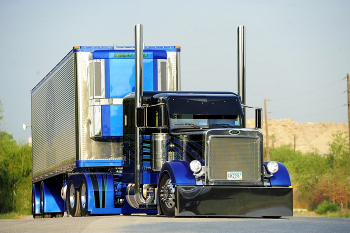Custom blue and black Peterbilt semi-truck with trailer