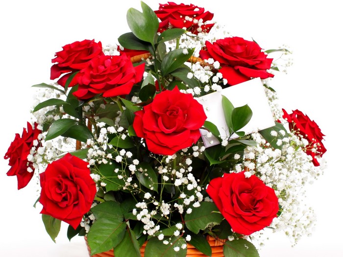 A basket of red roses with baby's breath and a card