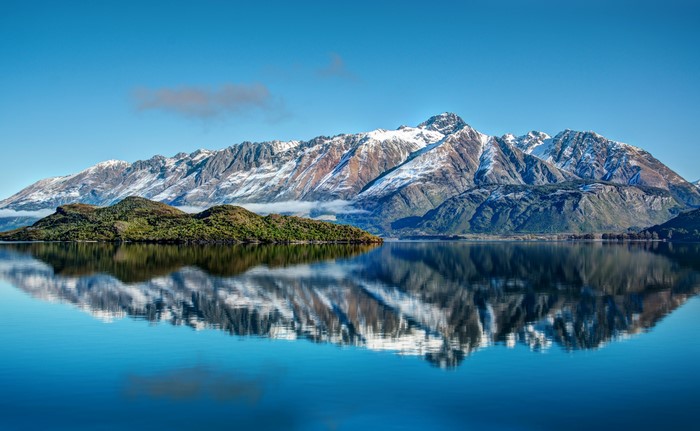 Snow-capped mountains reflected in a lake near Glenorchy, New Zealand