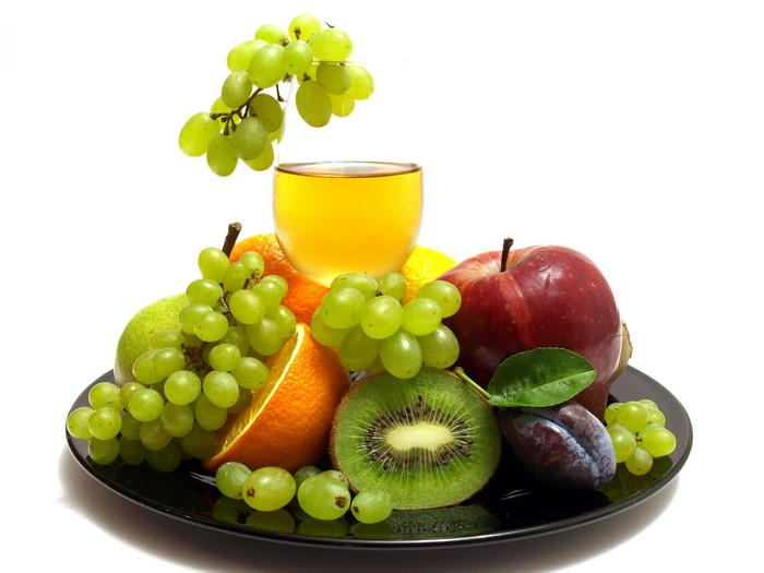 Assortment of fresh fruits and juice on a plate