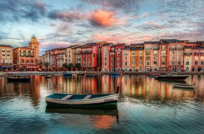 Colorful buildings on a canal with boats at sunset