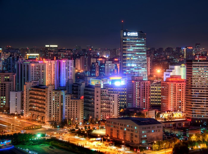 Night cityscape in China with illuminated skyscrapers