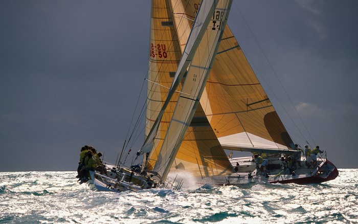 Two sailboats racing on choppy water