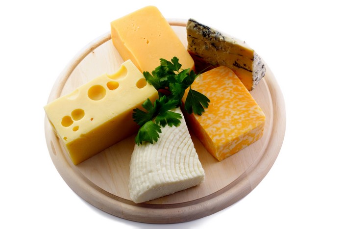 Assortment of cheeses on a wooden board