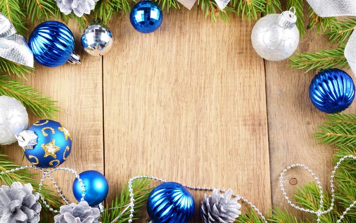 Christmas Ornaments and Pine Branches on Wood