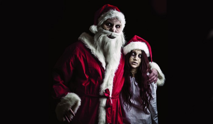 Creepy Santa Claus and Girl in Santa Hats