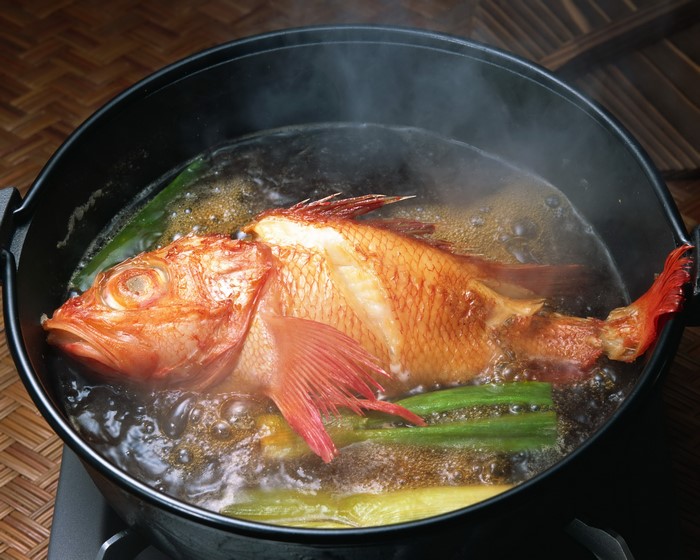 Whole Red Fish Being Poached in a Pot