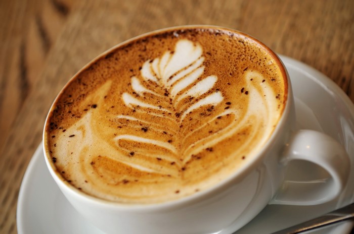 Cappuccino with latte art on a saucer