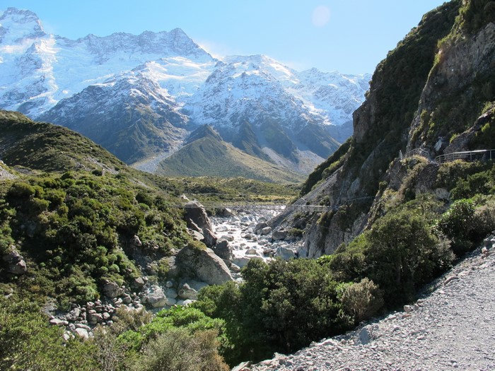 Snow-capped mountains and a rocky river valley in New Zealand