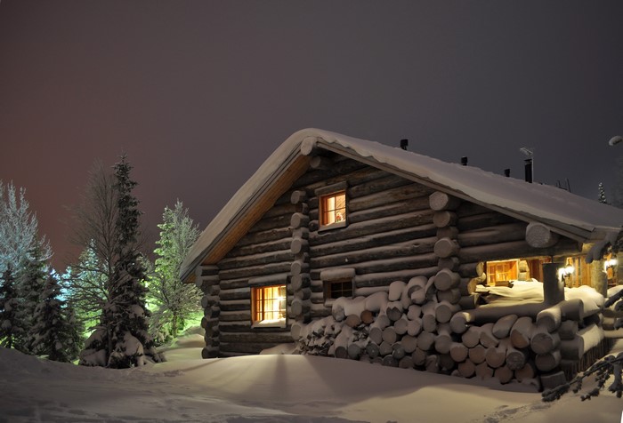 Log cabin in Finland at night during winter