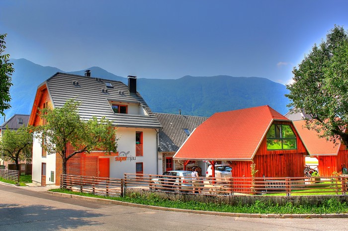 Modern houses in Bovec, Slovenia with mountains in background