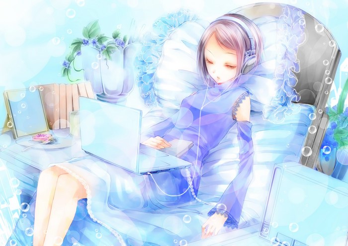 Girl with headphones using a laptop