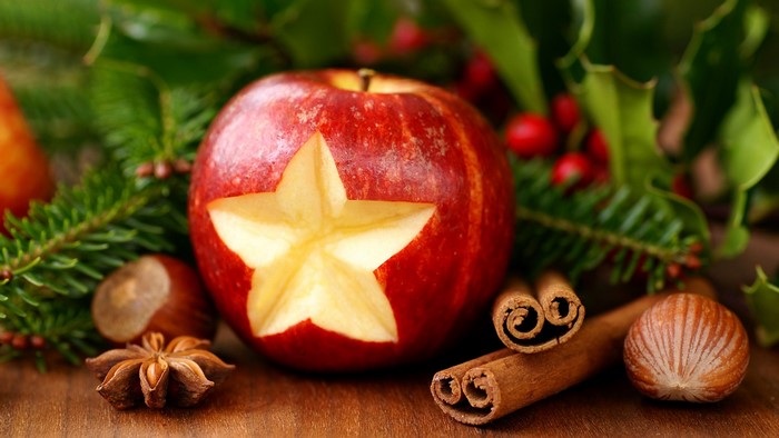 Apple with star carving and Christmas decorations