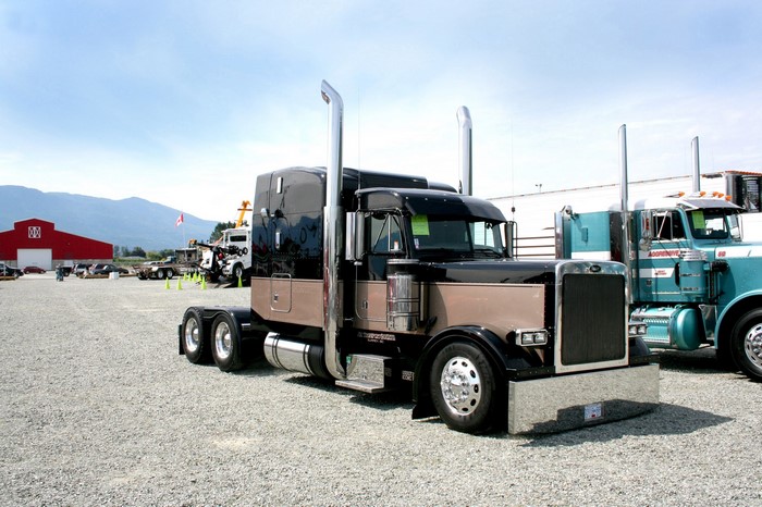 Peterbilt trucks parked on gravel lot
