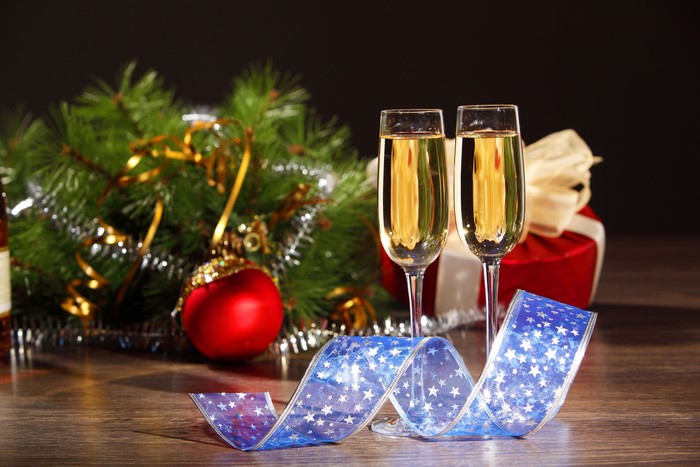 Champagne glasses with Christmas decorations and gift