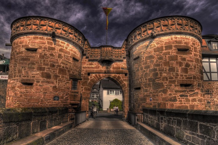 Historic stone gatehouse with towers and archway in Germany