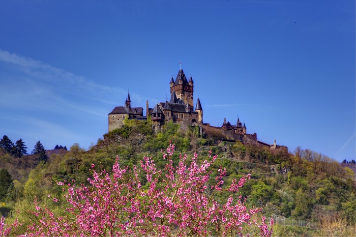 Reichsburg Cochem castle on a hill under a blue sky