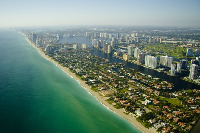 Aerial view of Miami coastline with high-rise buildings and canals