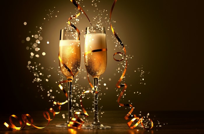 Champagne glasses with ribbons and sparkles